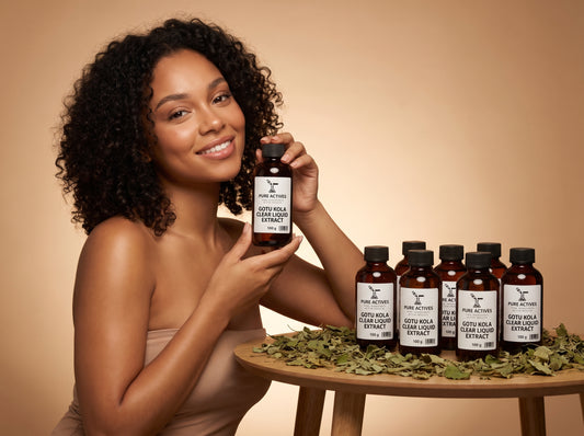 Model holding Pure Actives Gotu Kola Clear Liquid Extract bottle with dried centella leaves